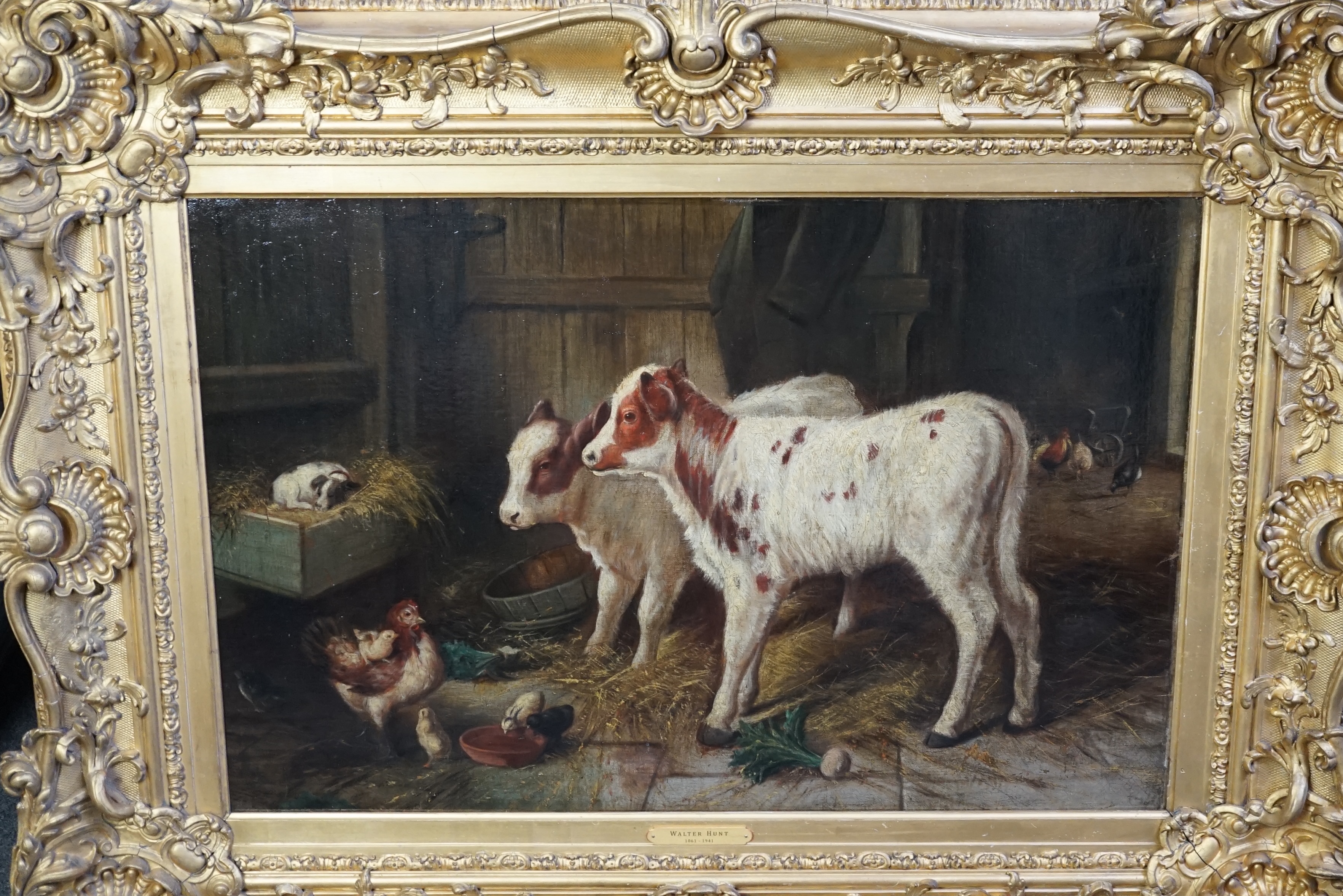 Walter Hunt (1861-1941), Calves, a puppy and poultry in a barn, oil on canvas, 50 x 75cm